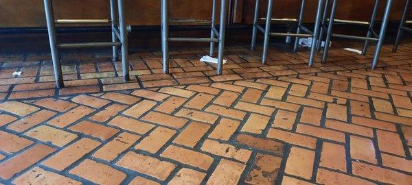 This is what the floor looked like around the entire bar area and booths not just what is pictured. Not once did any staff attempt to clean.