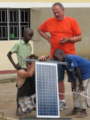 Team installing solar panels in the village