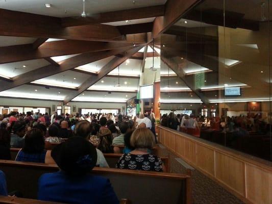 The main part of the church on the left and the glass partition on the right that separates the area for families with children