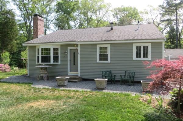 Stark white trim provides a superb contrast on this smaller home, highlighting the windows and front door.