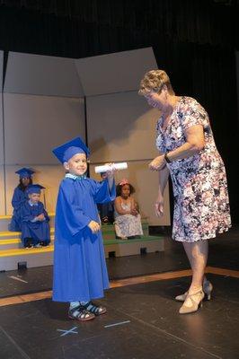 A Child's Voice student celebrates his graduation with Executive Director Dr. Michele Wilkins.