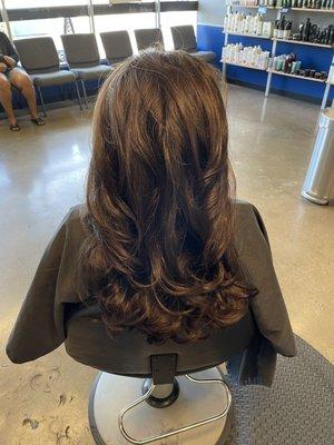 One length layered cut with a blowout style.