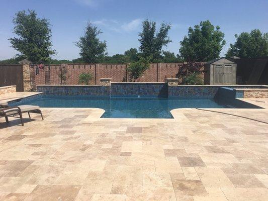 clean modern looking pool with travertine decking