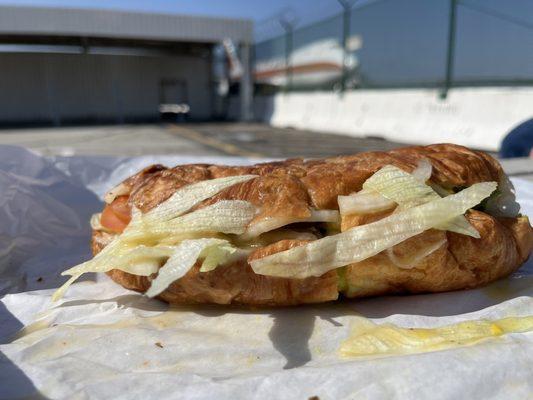 Veggie on croissant with 747 background