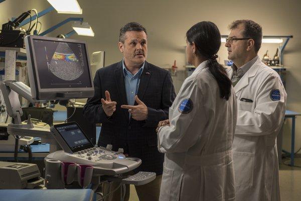 Ron Pellegrini, Vice President of Simens with Medisend College Director, Dr. Costel & Instructor Alapati discussing the Siemens Ultrasound.