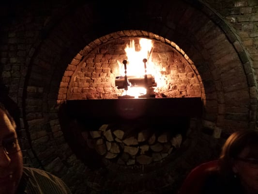 A beautiful fireplace in the middle of the dining room.