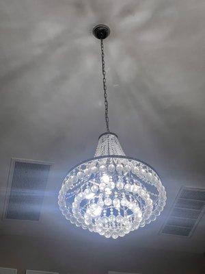 Chandelier installed, electrician knocked of bulbs and didn't secure chandelier.