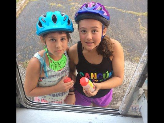 Kids on bycicles follow the ice cream truck to get ice cream!