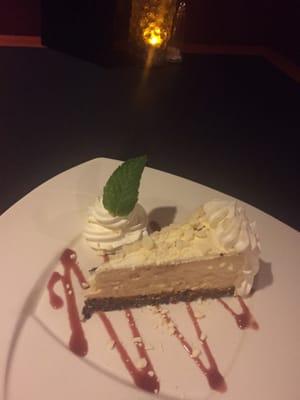 White Chocolate Cheesecake ~ Homemade white chocolate cheesecake with a dark chocolate cookie crust & raspberry sauce ~