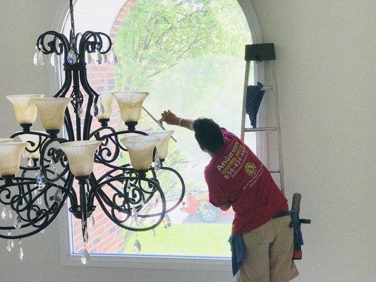 Cleaning a high picture window.