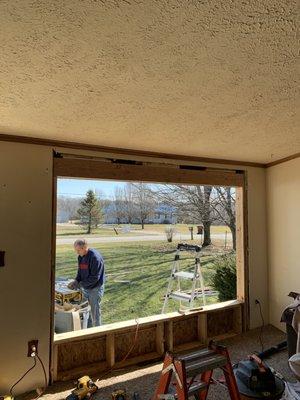 This was a blank wall. We cut in an opening, installed a new header, re-routed the electrical and later installed a large picture window.