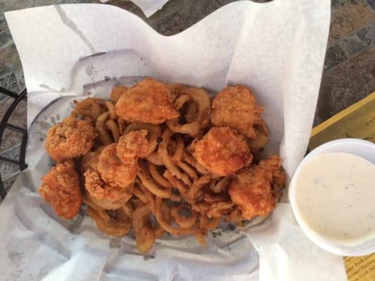 Boneless wings on a bed of fries and onion straws. $11