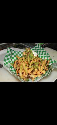 Carne asada fries- Comes with fries, asada, sour cream, guacamole, and two of our special sauces to give it that touch