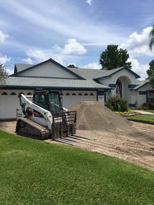 Ripping out a concrete driveway for new pavers.