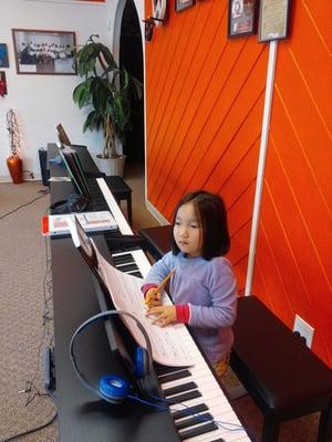 5 year old Uyen at her piano lesson.