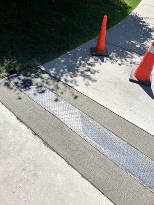 Concrete sidewalk with drain