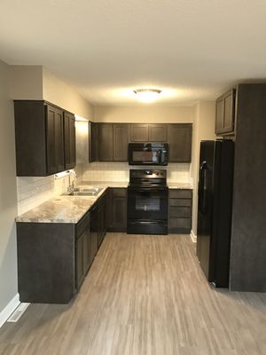 Glue down luxury vinyl planks with some Welborn Forest cabinets.