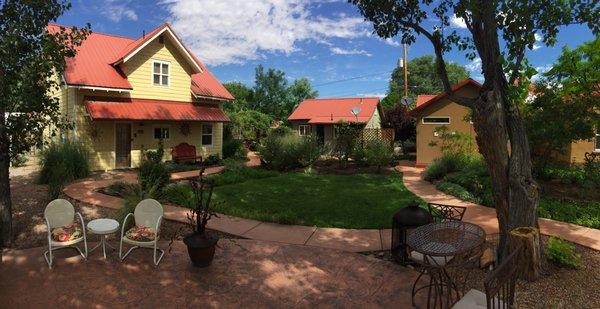 View of shared yard area (with BBQ Grill and Hot Tub) Cottages shown from left to right : French Quarter / Bogie's Bungalow / Moosewood