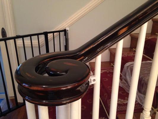 Custom faux finish on a cherry handrail.