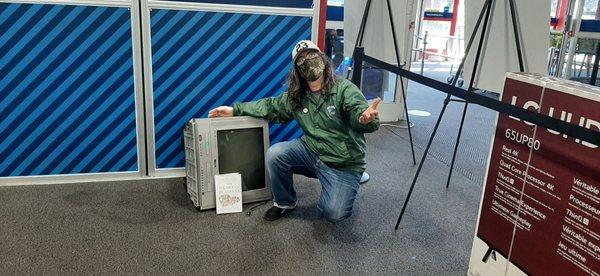 Abandoned television in the customer service line. Posing customer with Joly book on Best Buy miracle story.