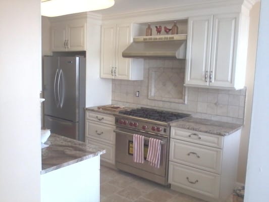 After photo of kitchen demo picture, Wolf range, hood, tile backsplash design, subzero fridge.