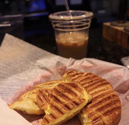 Breakfast Egg & Cheese Croissant with hazelnut iced coffee.