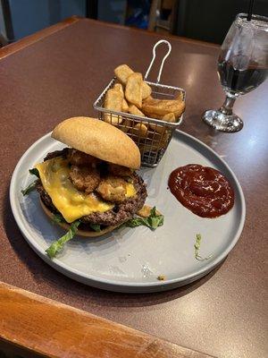 Wisconsin burger with cheese curds on it and fries