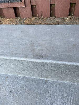 footprint left by AMCO guy exiting barefoot and stepping on the edge of still-wet patio step