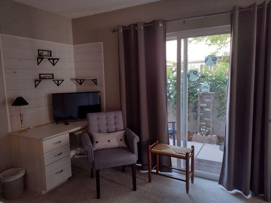 The master bedroom view with work desk space, tv and slider glass door out to your own private patio sitting area