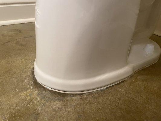 Leaking toilet at the base. Old caulking. Rocking no shims.