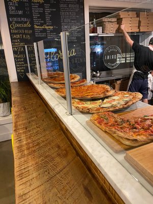 Pizzas ready to go, you can choose a slice from these options