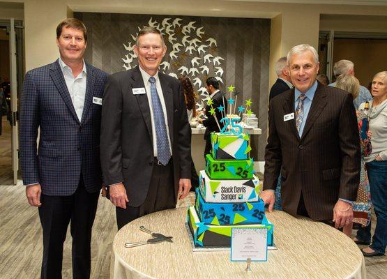 Ladd Sanger, Mike Davis, and Mike Slack celebrating the firm's 25th anniversary.