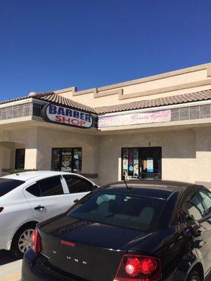 Front of the barber shop. You can see it from Hesperia road. Don't miss out on this place! Great cuts at great prices!