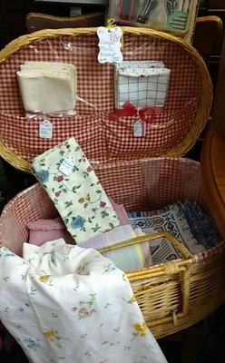 Picnic basket great for storage when not on a picnic! Vintage tablecloth, napkins, aprons and placemats.