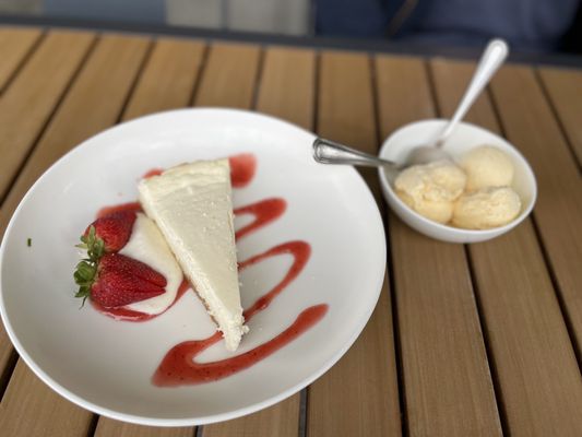 Strawberry cheesecake with vanilla ice cream.