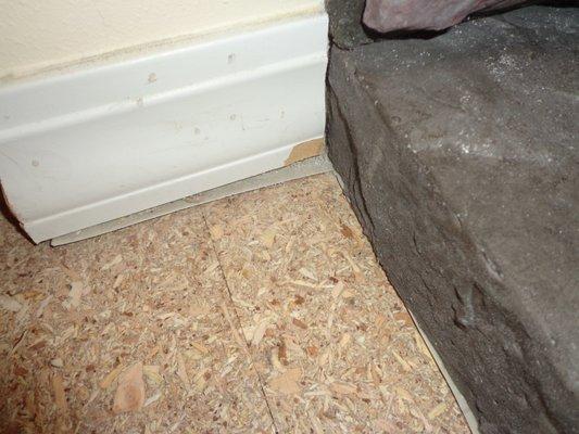 Damaged woodwork by fireplace by American Carpet