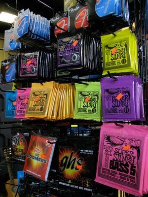 Electric guitar string brands include Ernie Ball, Fender, GHS and Dunlop.