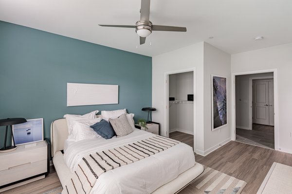 Bright bedroom with a ceiling fan at Glen Oaks Apartments in Wall Township, NJ.