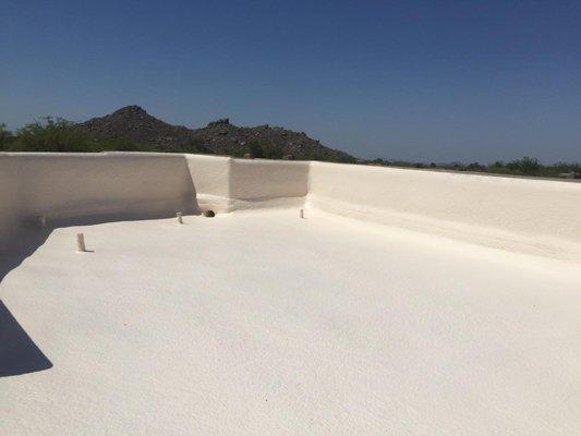 New foam roof with foam up and over cracked parapet walls