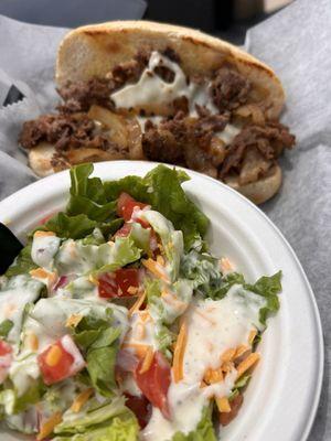 Philly cheesesteak with side salad