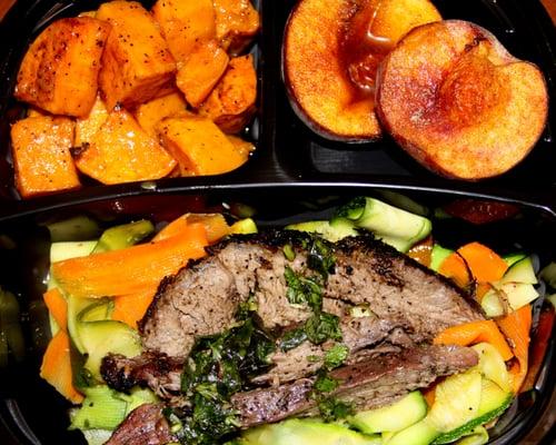 Grilled flank steak on a bed of summer vegetable ribbons served with roasted sweet potatoes and roasted cinnamon peach.