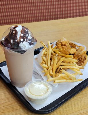 A split, garlic aioli dipping sauce and a chocolate milkshake