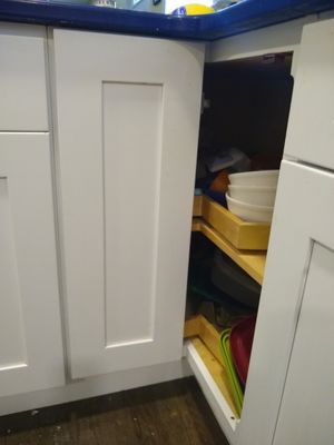 Half of the cabinet door that is still attached