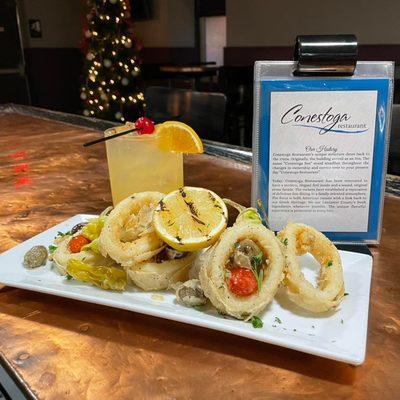 The Caribbean Christmas Cocktail paired with freshly flash fried tender calamari, olives, grape tomatoes, and pepperoncini w/ a lemon.