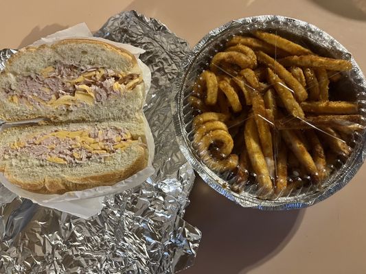 Chopped turkey on a roll and seasoned fries