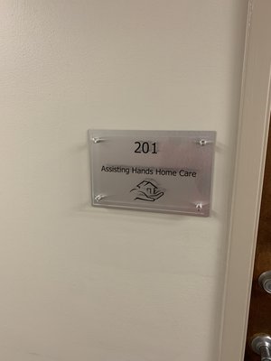 Suite sign with addition of the Assisting Hands logo!