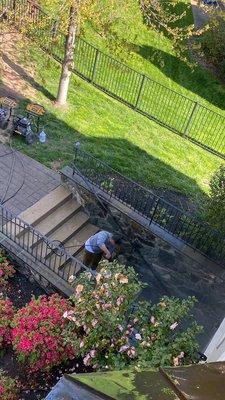 Here I am doing power wash outside of the stairs and on the side the wall.