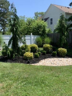 Flower bed done by us! Plants rocks and mulch