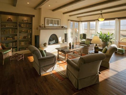 New Mexico Territorial Home with Kiva Fireplace and reclaimed wood bookshelf