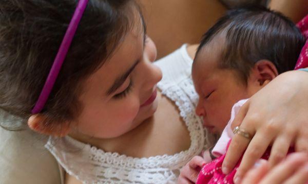 Big sister admiring the new baby